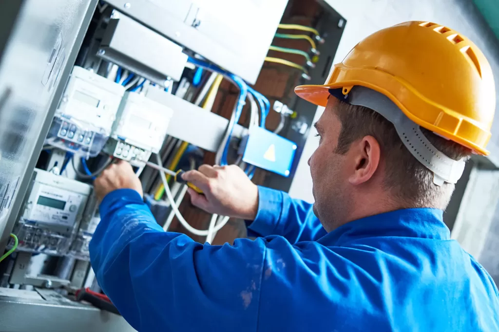 Telecom worker working on electrical panel